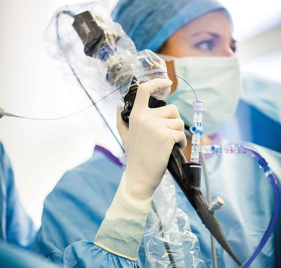 Female doctor during a urological laser therapy procedure  